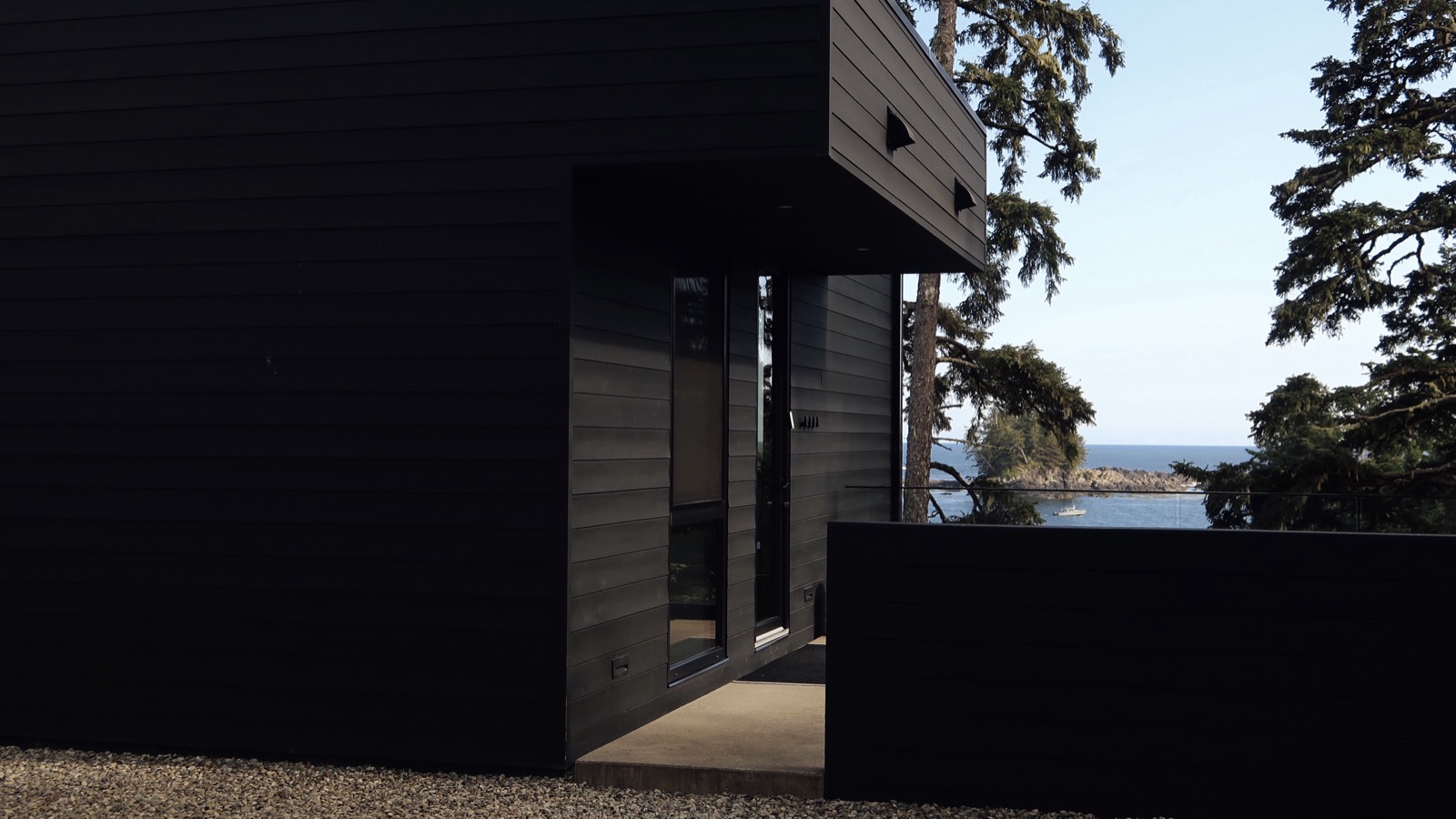 A corner of the house opening to the Pacific through the trees