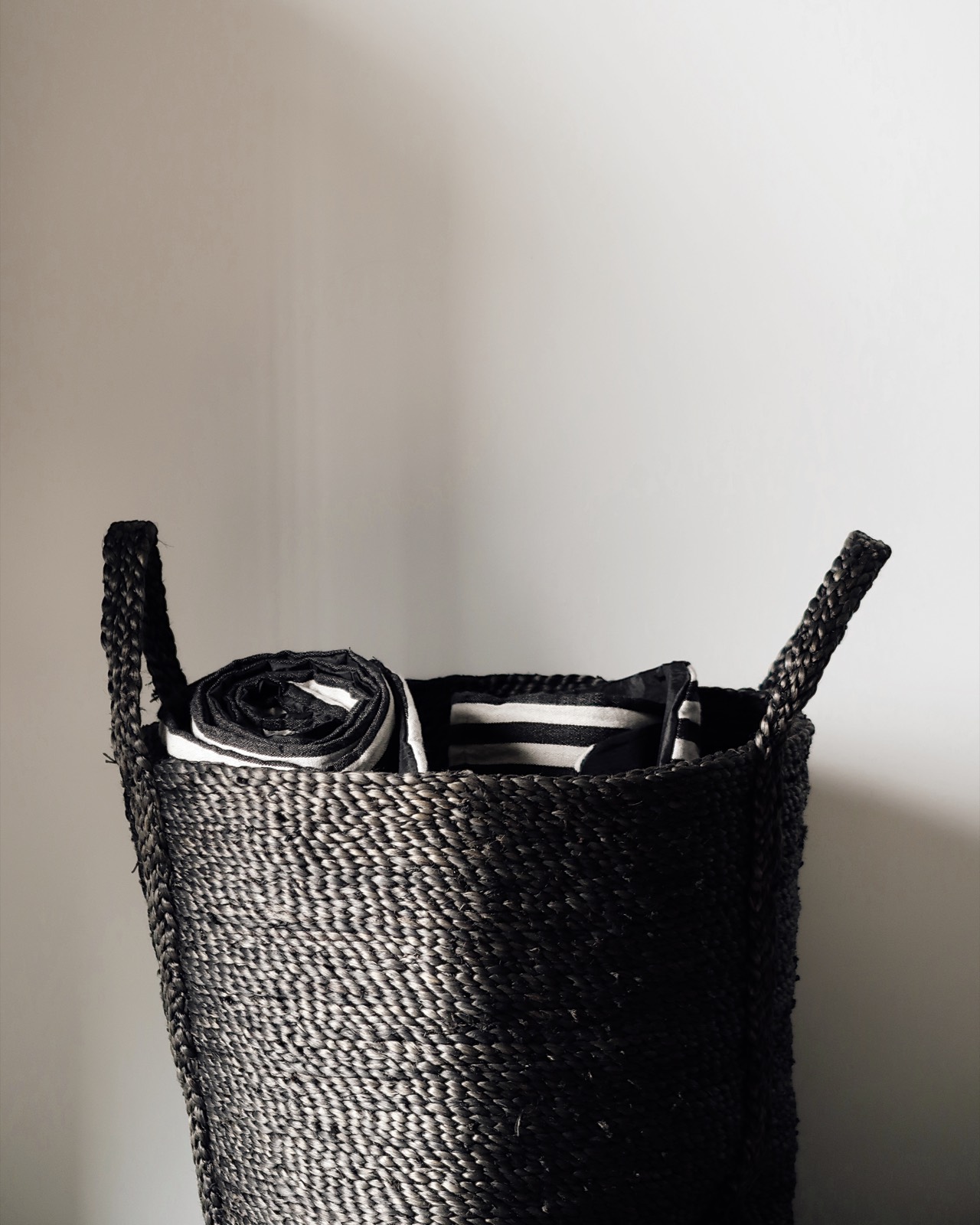 Rolled towels in a woven basket, a quiet spa detail