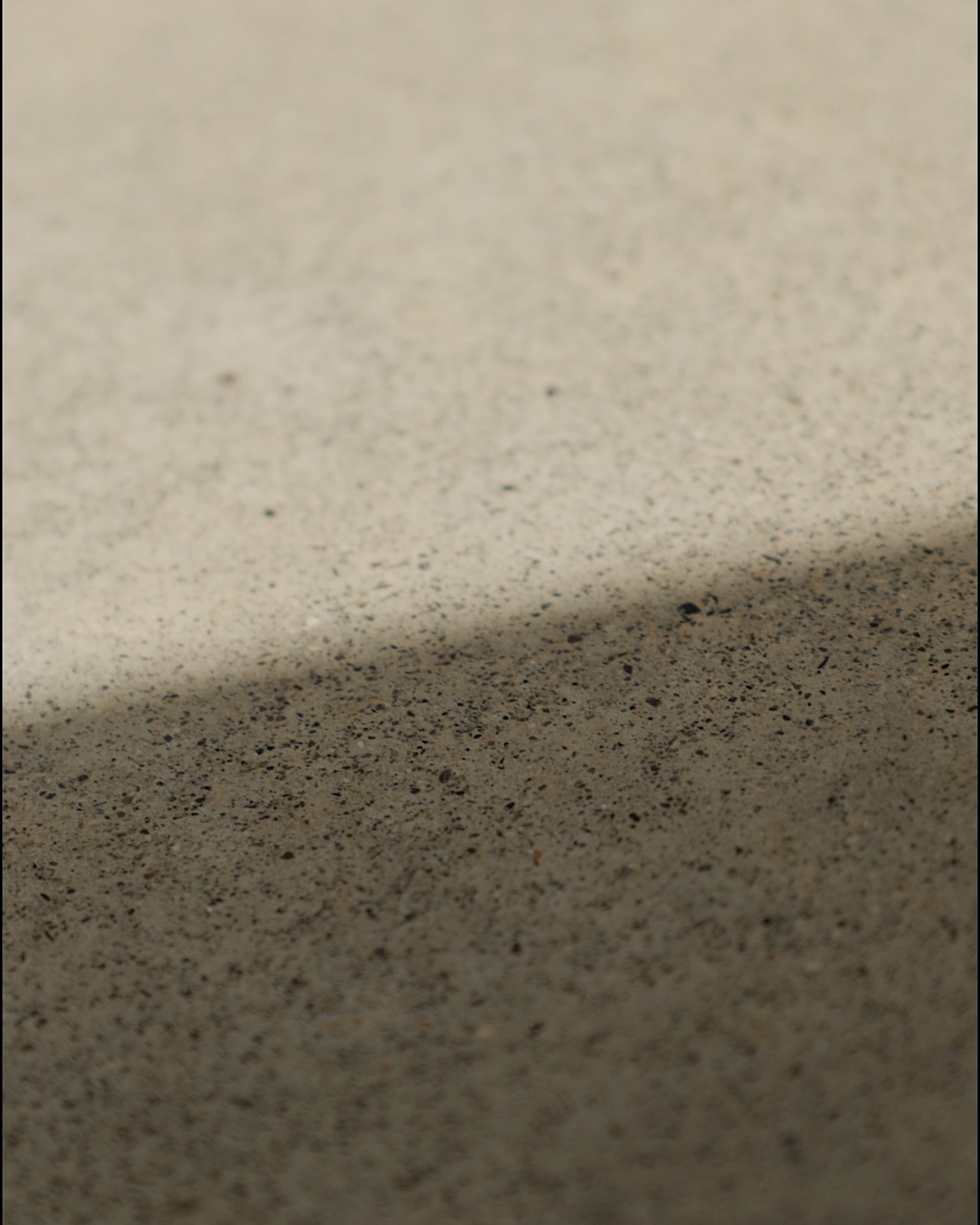 Soft morning light across a minimalist textured surface