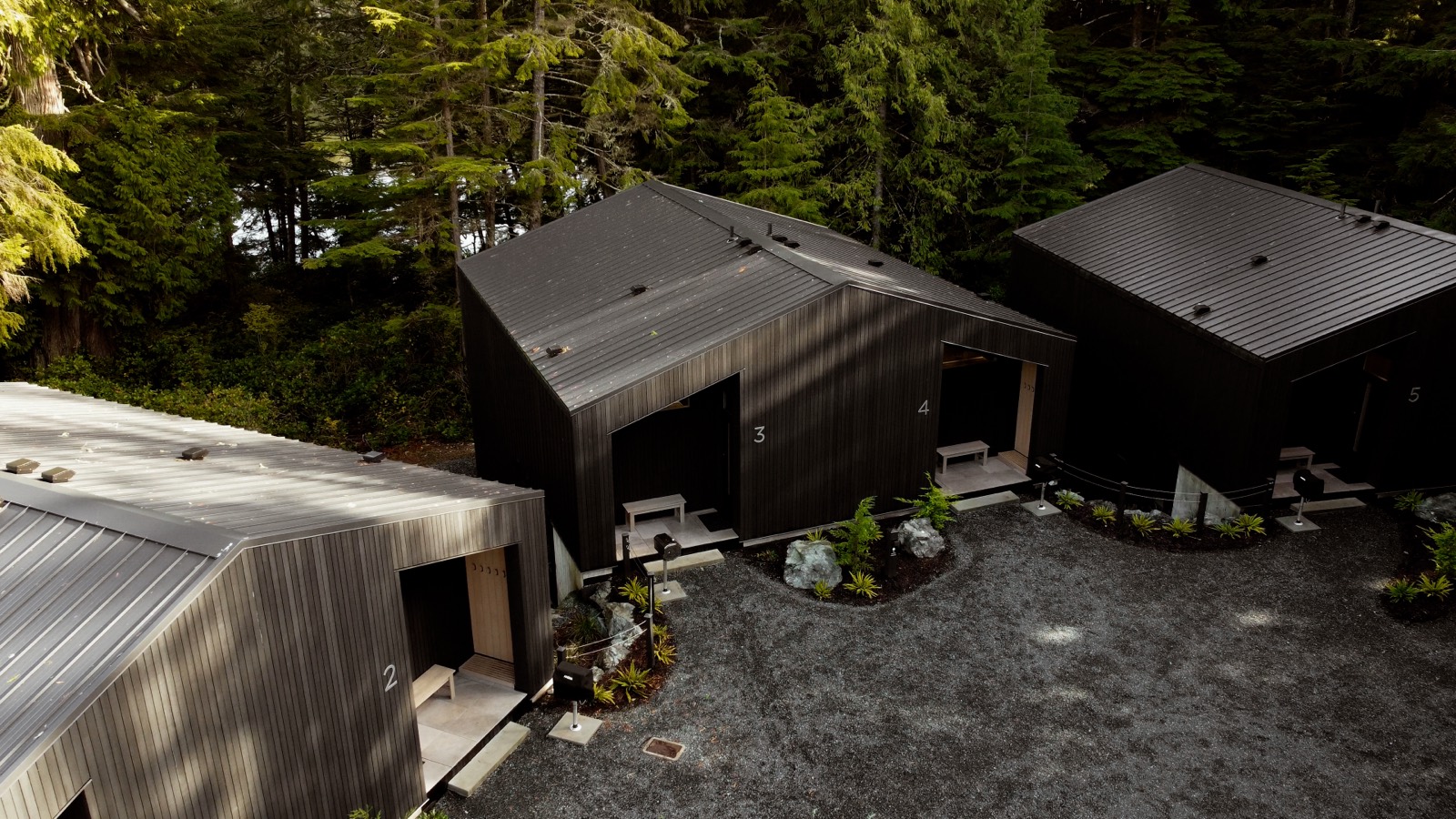 The black cedar cabins of the retreat from above