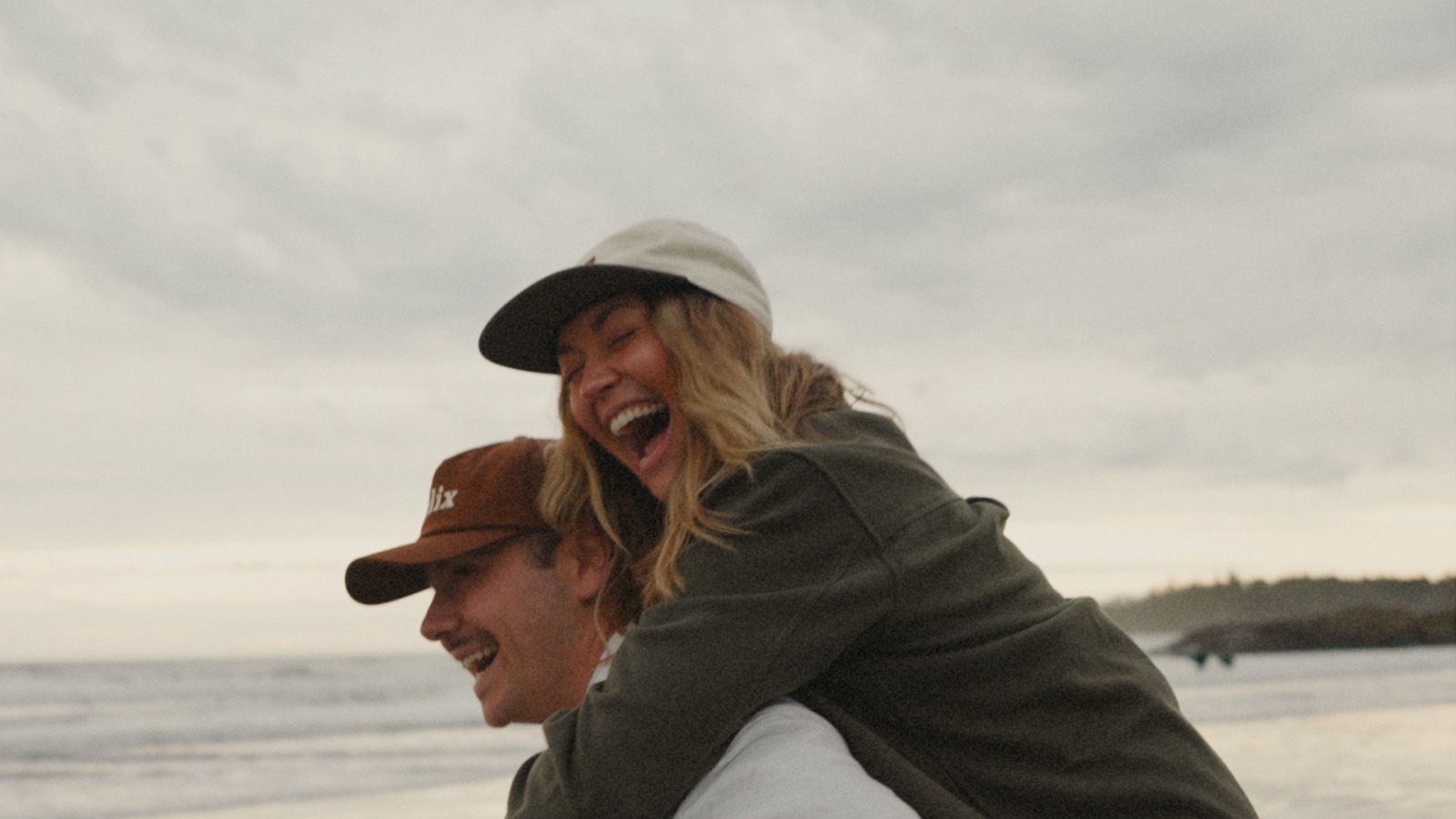 Jordan and Kaitlyn laughing together on the beach, Kaitlyn on Jordan's back